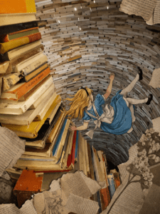 alice in wonder falling into a hole made of books